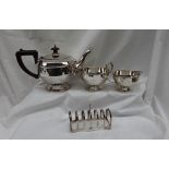 A George V silver three piece pedestal tea set, of stepped tapering form on a spreading foot,