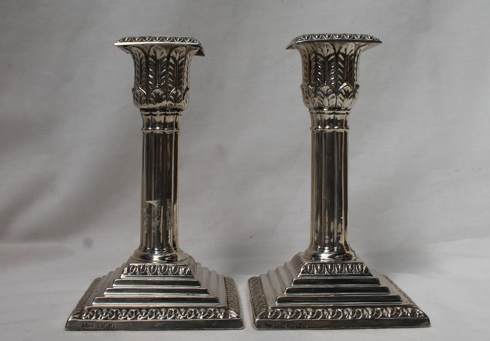 A pair of Edwardian silver candlesticks,