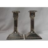 A pair of Edwardian silver candlesticks,