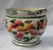 A Llanelly pottery jardiniere, with a shaped rim, painted with poppies and leaves, 19.