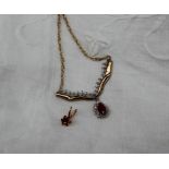 A ruby and diamond pendant to a 9ct yellow gold setting and chain,