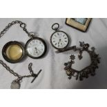 A white metal open faced pocket watch,