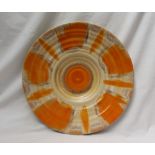A Shelley pottery charger, decorated in oranges and browns, 35.