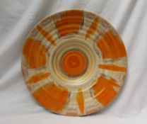 A Shelley pottery charger, decorated in oranges and browns, 35.