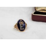 A 19th century diamond enamel and yellow metal ring with the letter "E" picked out in rose diamonds