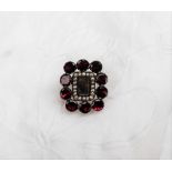 A Garnet and seed pearl set mourning brooch,