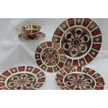 A Royal Crown Derby 1128 pattern dinner plate together with a bread and butter plate, side plate,