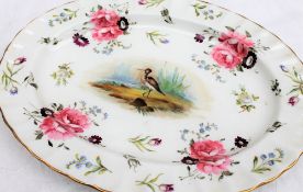 A 19th century English porcelain oval dish, painted to the centre with a wading bird,