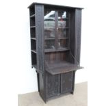 An early 20th century carved and stained pine bureau bookcase display cabinet,
