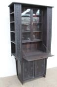 An early 20th century carved and stained pine bureau bookcase display cabinet,