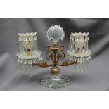 A 19th century gilt metal and cut glass twin branch candelabra, with a central glass fan,