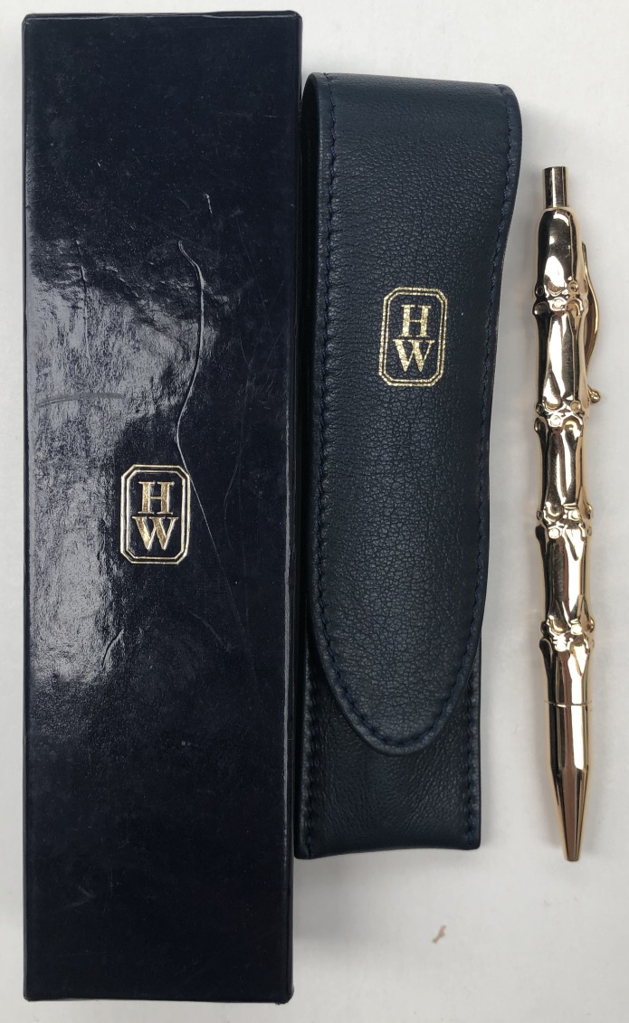 Harry Winston - A 14K yellow gold ball point pen of stylised bamboo design, 13cm long,