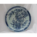 A large Japanese blue and white porcelain charger, decorated to the centre with birds amongst trees,