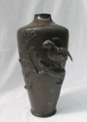 A Japanese bronze vase of tapering cylindrical form cast with an eagle on a branch,