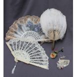 A feather fan, with a bone handle,