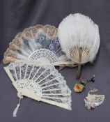 A feather fan, with a bone handle,