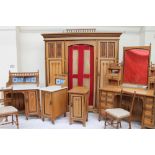 An Arts and Crafts light oak bedroom suite, comprising a triple wardrobe, wash stand,
