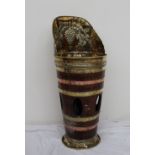 A coopered and brass umbrella stand, the raised back embossed with grapes and leaves,