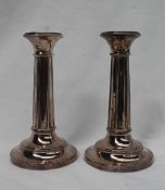 A pair of George V silver candlesticks,