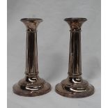 A pair of George V silver candlesticks,