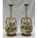 A pair of Royal Worcester twin handled vases in the Persian style,