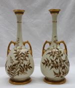 A pair of Royal Worcester twin handled vases in the Persian style,