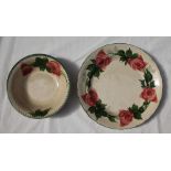 A Llanelly pottery tea rose decorated plate, with a green line rim,