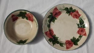 A Llanelly pottery tea rose decorated plate, with a green line rim,