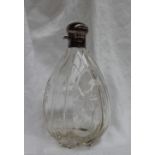 A George V silver topped and glass spirit flask, of tear drop shape,
