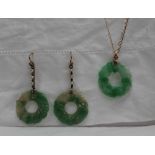 A green and white jade pendant of circular form on a yellow metal chain together with a pair of