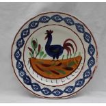 A Llanelly pottery plate, painted with a blue cockerel,