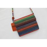 A 1980's Missoni handbag, with tradmark wave pattern in plastics coloured greens, blues and oranges,