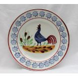 A Llanelly pottery plate, painted with a blue cockerel,