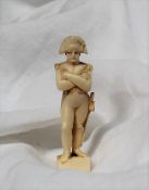A 19th century ivory figure of Napoleon, with arms folded, on a circular base, 5.