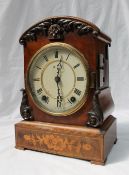A Victorian walnut cuckoo clock, with an arched top, with leaf carving,