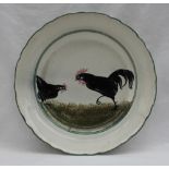 A Llanelly pottery plate painted with a hen and cock in black, within a green line border,