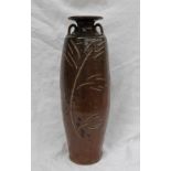 A studio pottery twin handled vase, with a brown ground and incised leaf and floral decoration,