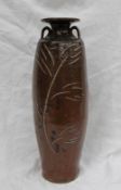 A studio pottery twin handled vase, with a brown ground and incised leaf and floral decoration,