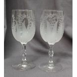 A pair of 19th century engraved glass wine glasses,