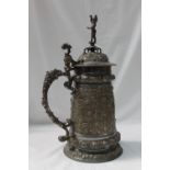 A WMF electroplated lidded stein, with a cherub in a helmet holding a flaming torch terminal,