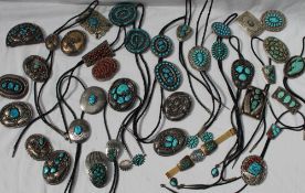 A collection of Spenser sterling, nickel and white metal Navajo belt buckles and bolos,