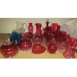 A collection of cranberry glass including jugs, goblets, dishes etc together with clear glass jugs,