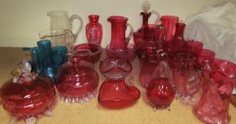 A collection of cranberry glass including jugs, goblets, dishes etc together with clear glass jugs,