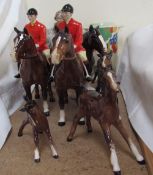 Two Beswick huntsmen in pink jackets on bay horses together with Beswick foals,