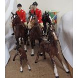 Two Beswick huntsmen in pink jackets on bay horses together with Beswick foals,