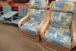 A pair of upholstered conservatory armchairs together with a green painted garden bench set