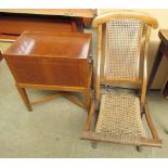 A folding chair together with a walnut chest on stand