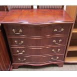 A reproduction yew chest of drawers with a serpentine front
