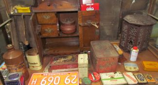 An oak tobacco pipe cabinet together with assorted tins,