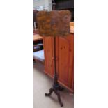 A Victorian mahogany pole screen with printed screen on a reeded base and three legs